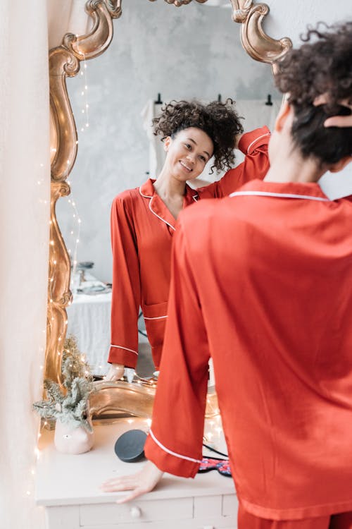 Woman in Red Pajama Looking at the Mirror