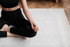 A person meditating indoors, emphasizing relaxation and mindfulness.
