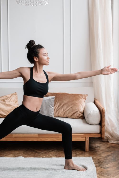 Free A serene moment captured of a woman doing yoga in a peaceful home setting, emphasizing wellness. Stock Photo