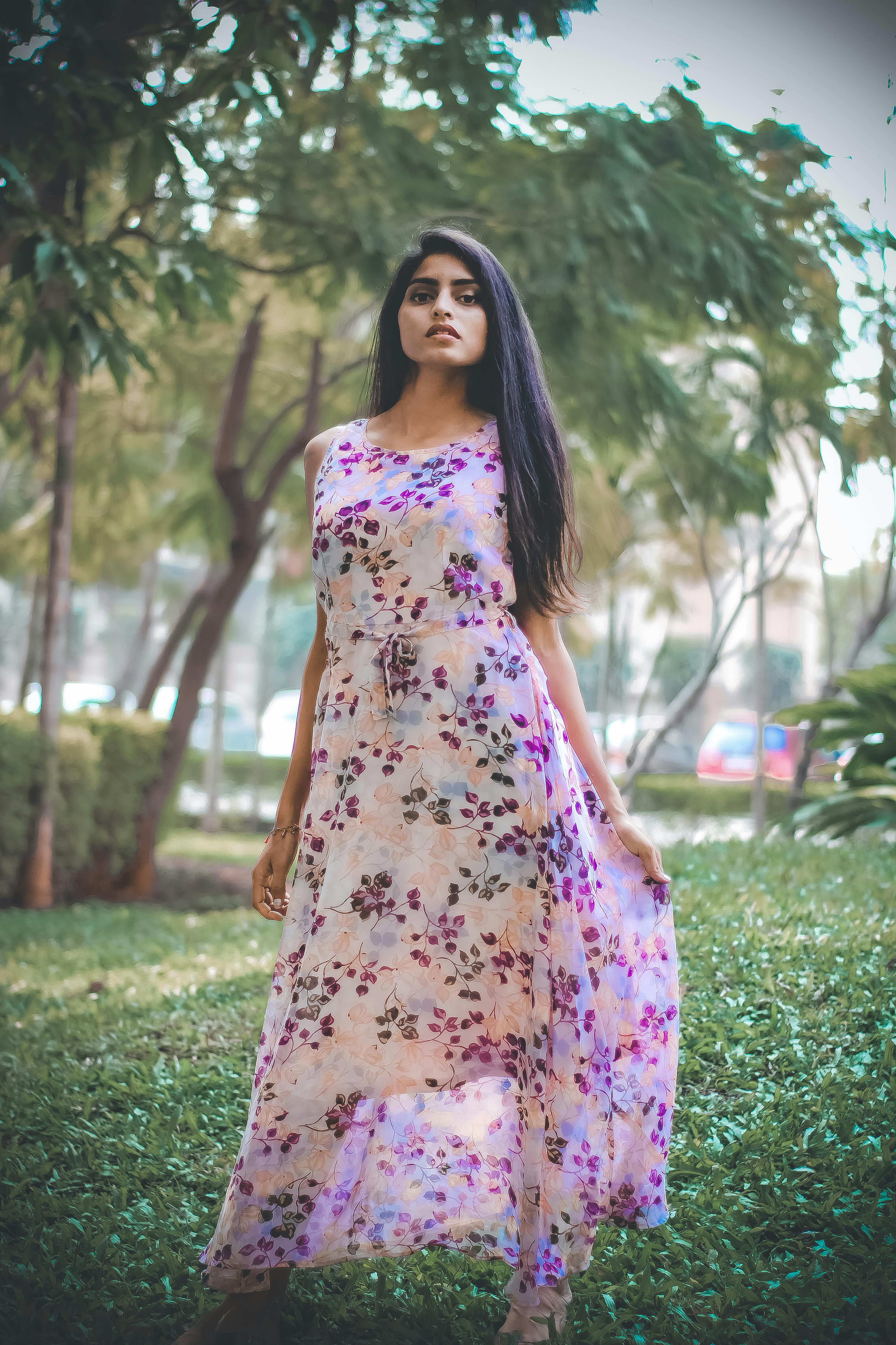 Woman in Floral Dress Standing in Park  Free Stock Photo