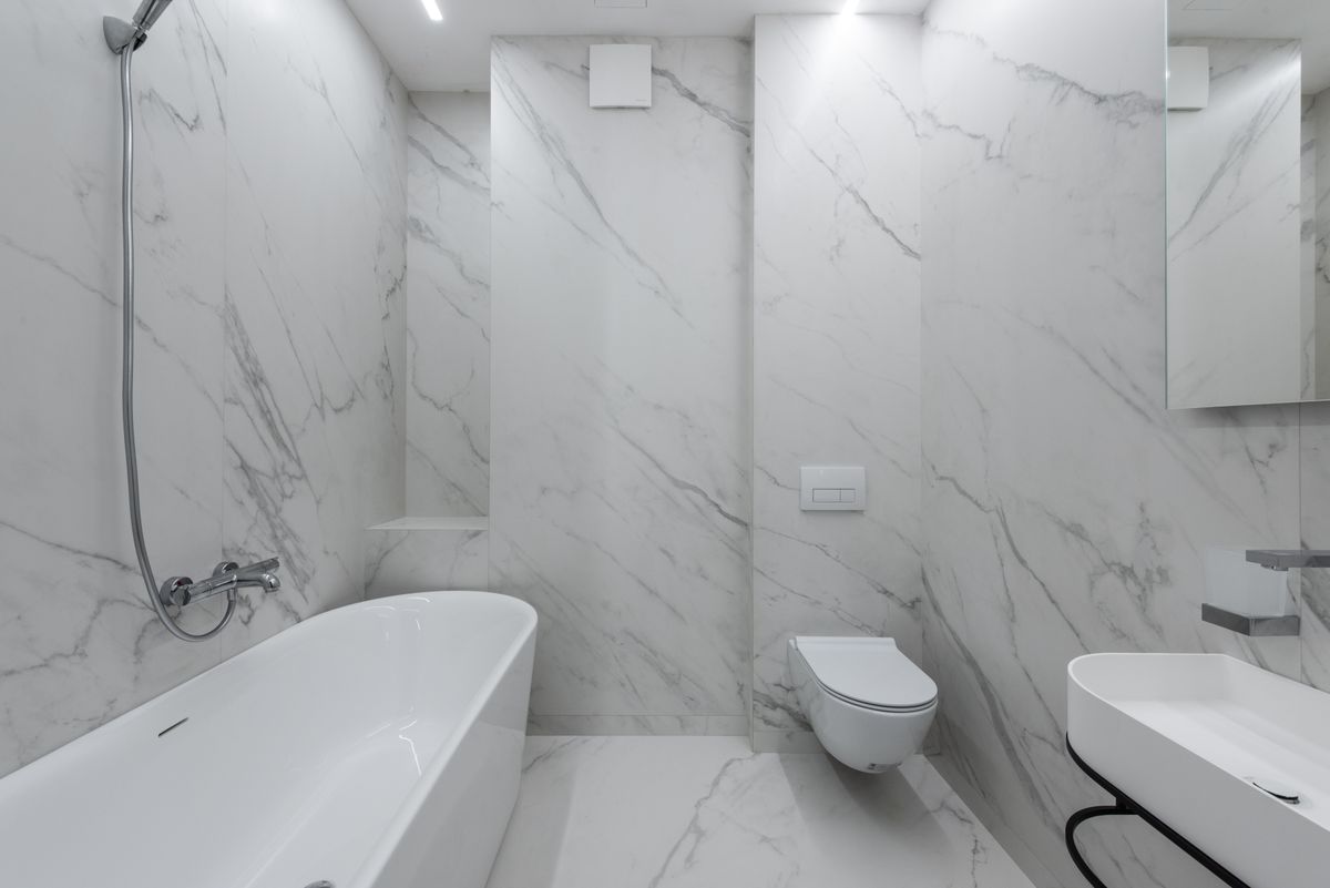 green tiled modern wet room with brass fittings