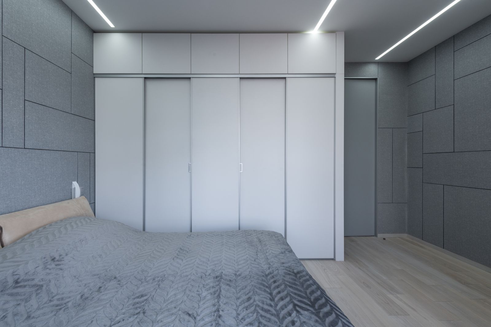 Contemporary bedroom with stylish ceiling lighting and neutral interiors