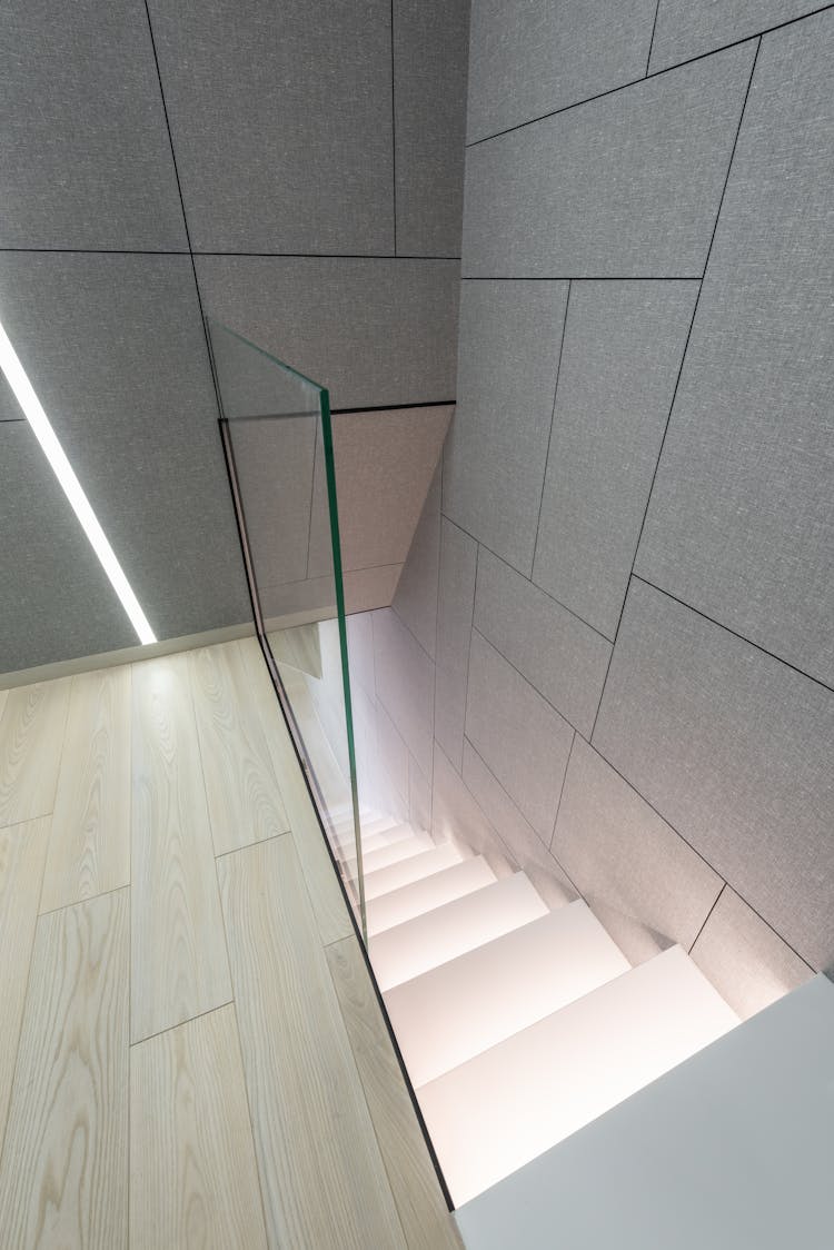 Modern Building Interior With Staircase With Glass Railing Near Wall