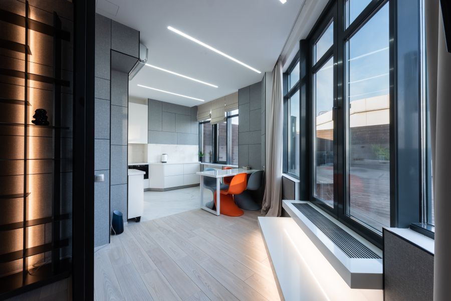 Contemporary interior with dark-framed floor-to-ceiling glazing
