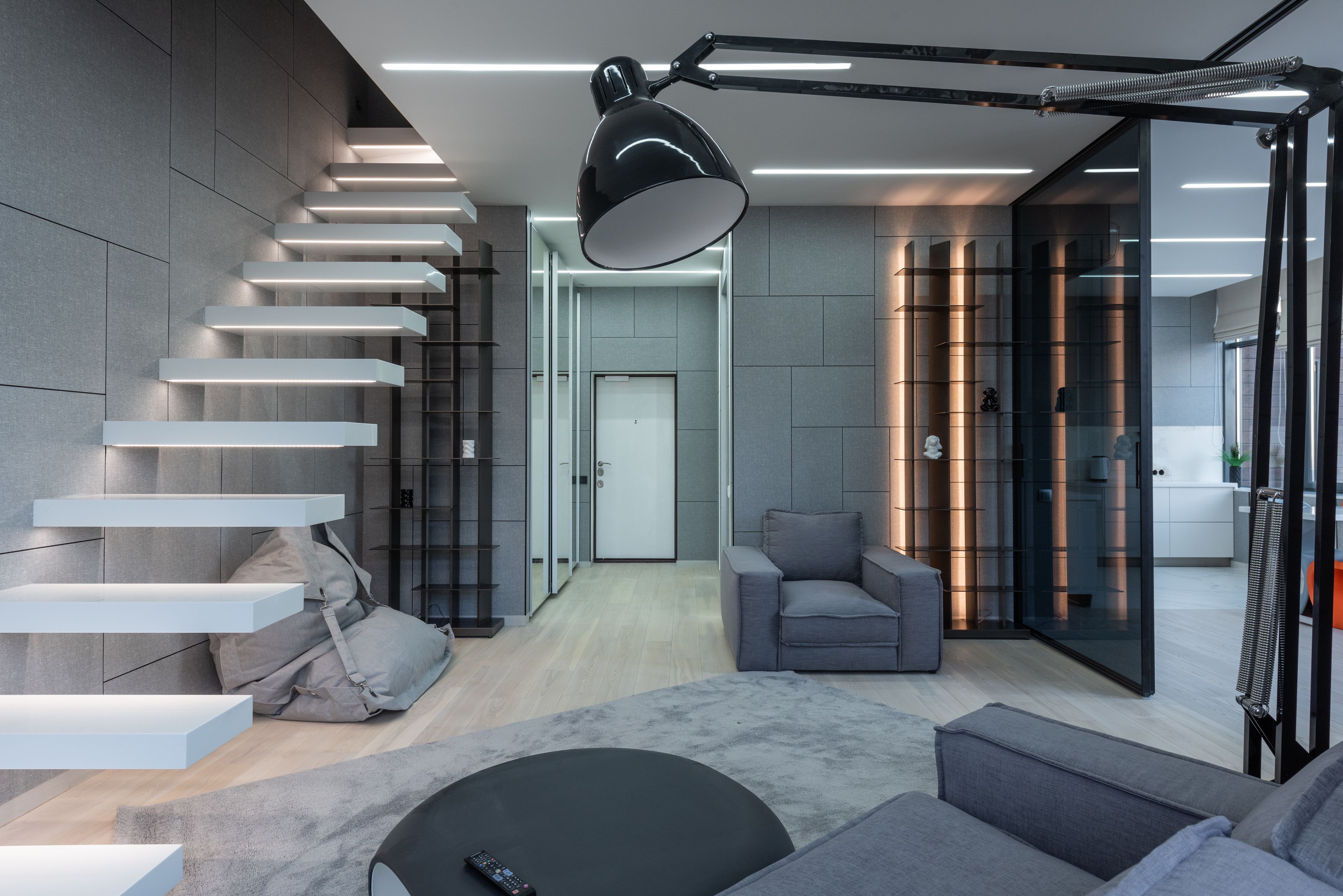 A loft with a floating stair and one black lamp