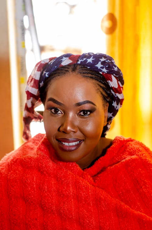 Black woman with bright makeup and USA cloth on head