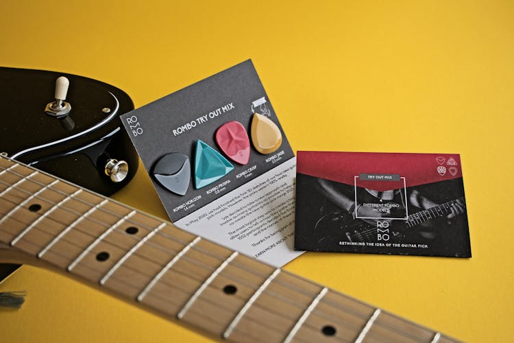 Guitar Parts And Accessories On A Yellow Surface