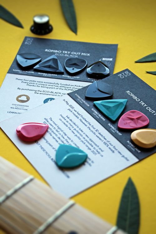 Free Set of vibrant Rombo guitar picks arranged artistically on product cards. Stock Photo