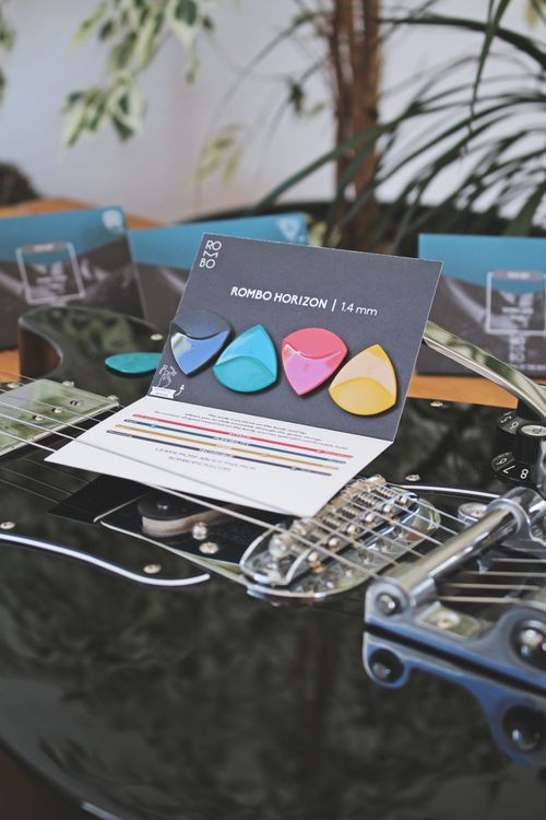 Free Close-up of vibrant guitar picks on a glossy electric guitar. Stock Photo