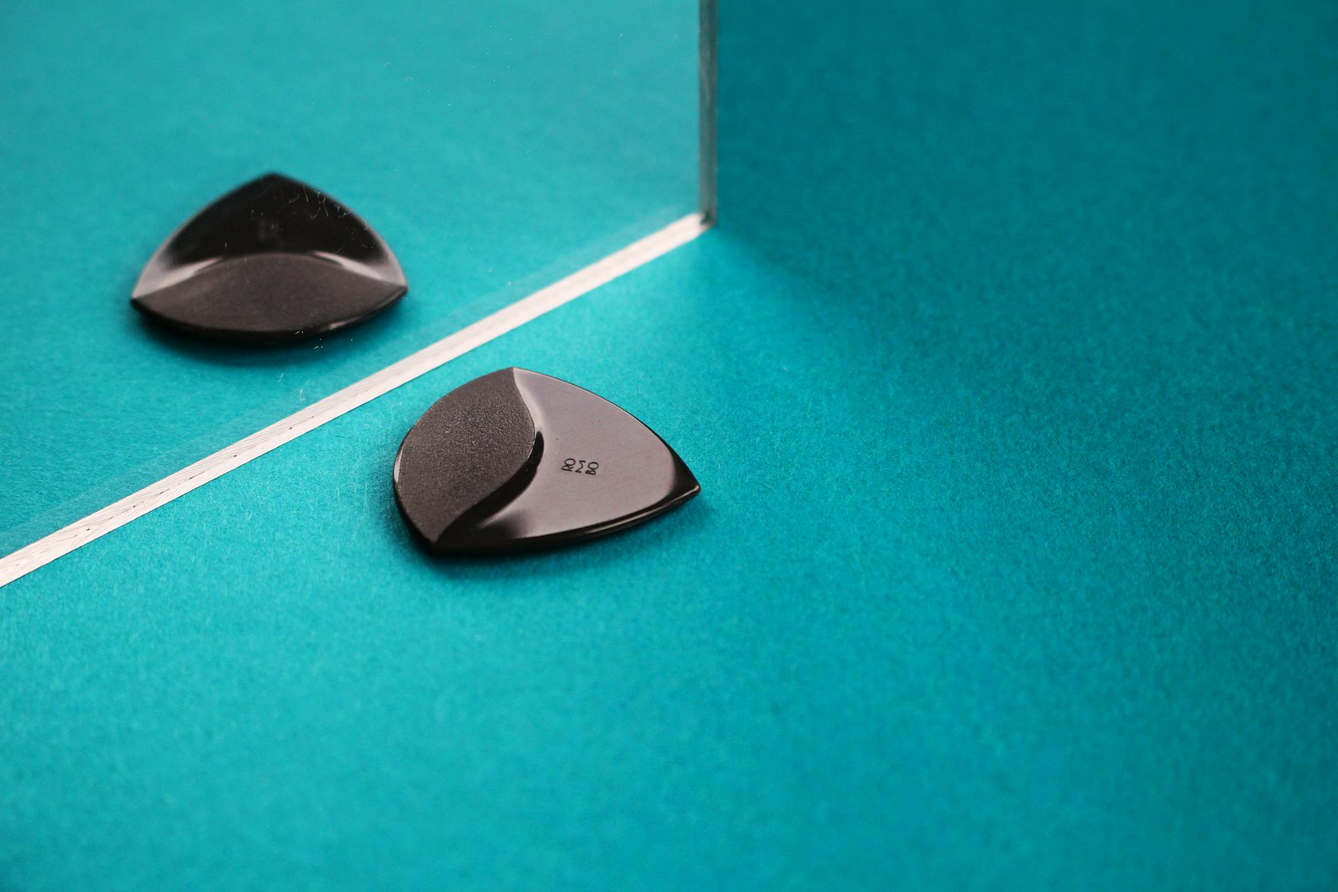 Heart Shape Guitar Pick on Green Surface