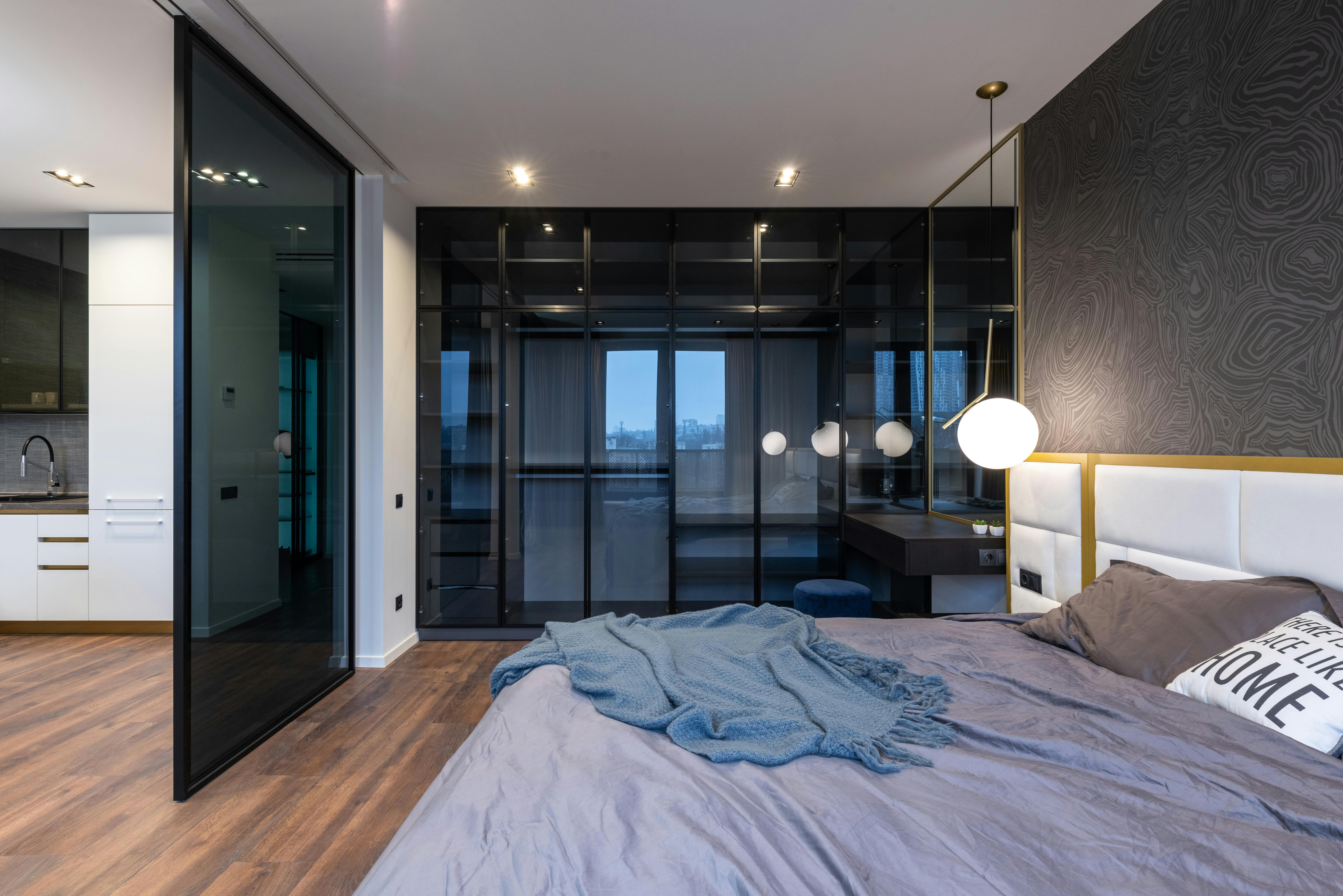 Modern apartment interior with bed near kitchen · Free Stock Photo