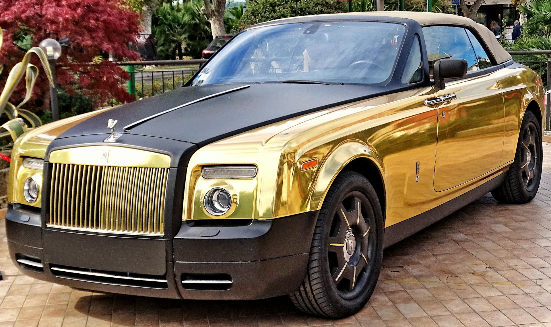 A Gold and Black Rolls Royce Phantom Drophead Coupe