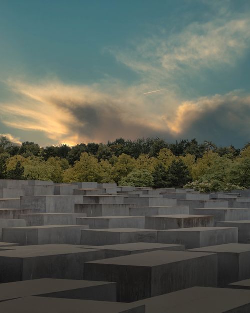 Free Holocaust Memorial in Berlin captured at sunset, showcasing its solemn architecture. Stock Photo