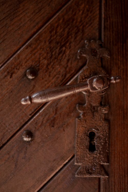 Free Vintage metal keyhole on heavy wooden door Stock Photo