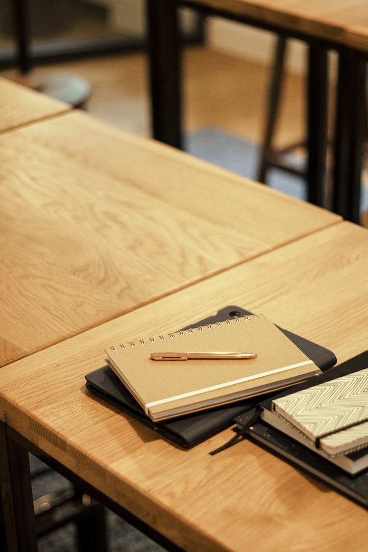 Close-up Of Notebooks And Tablets On A Wooden Table