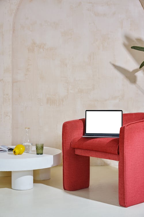 Free Laptop on a Red Chair Stock Photo