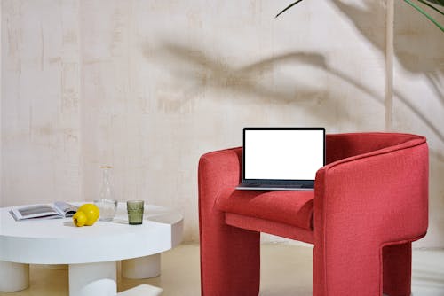 Laptop on a Red Armchair near Table