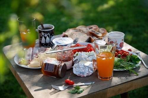 A Wooden Table with Foods and Drinks