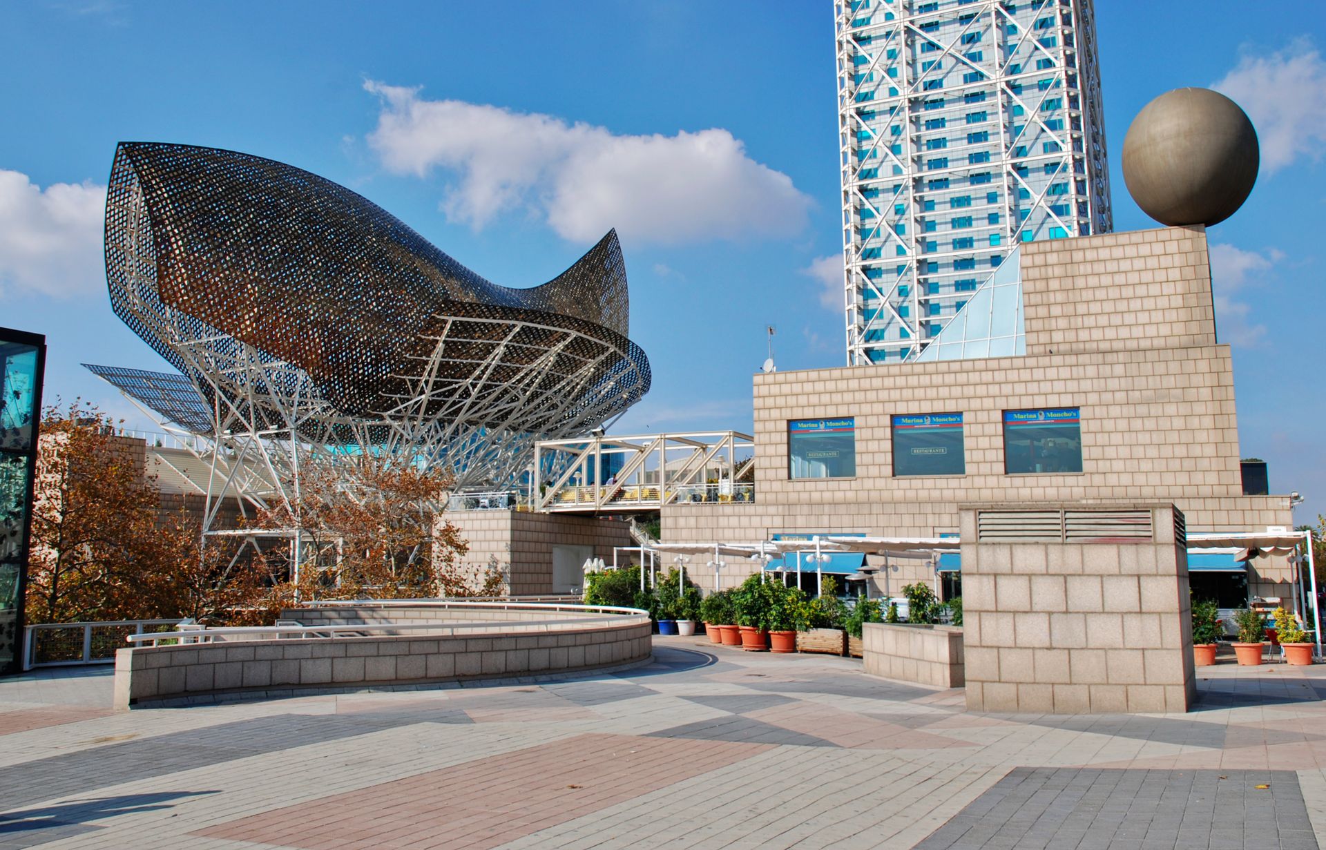 Iconic Peix Olímpic sculpture by Frank Gehry with modern architecture in Barcelona's urban area.