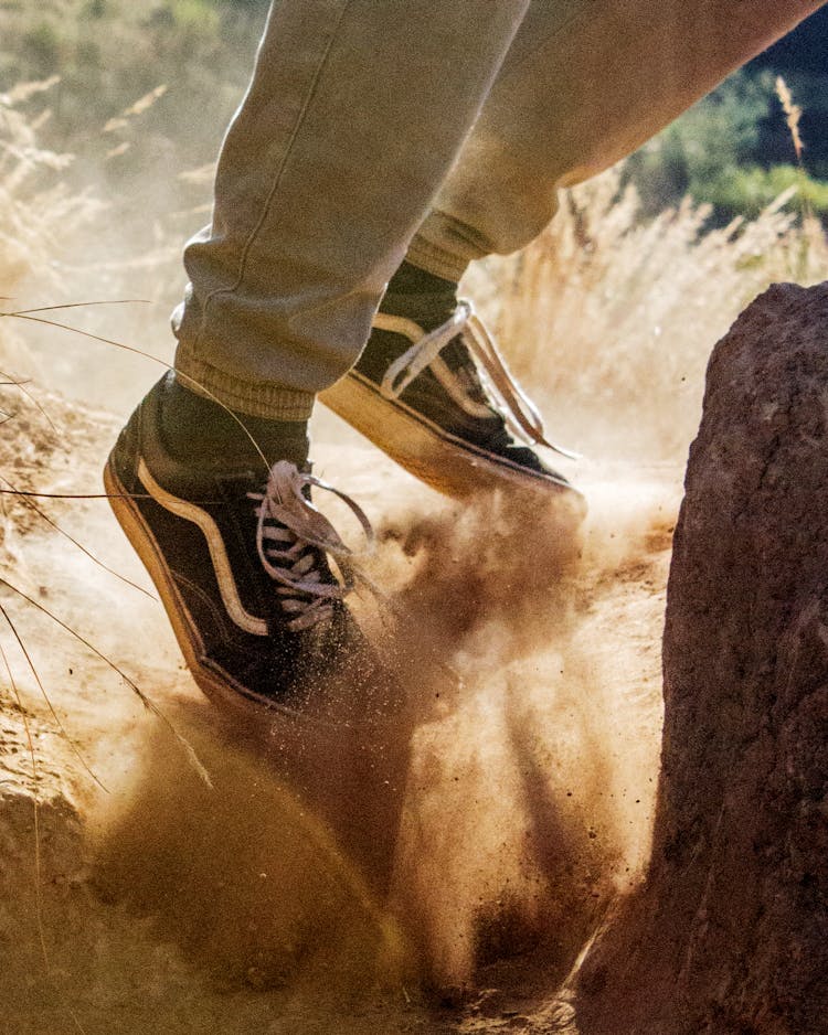 A Person Jumping In The Dirt