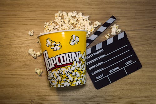Free Overhead Shot of a Bucket of Popcorn and a Clapperboard Stock Photo