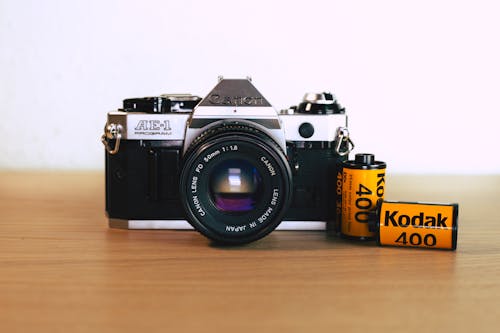 Free Close-up of an SLR Camera and Rolls of Film Stock Photo