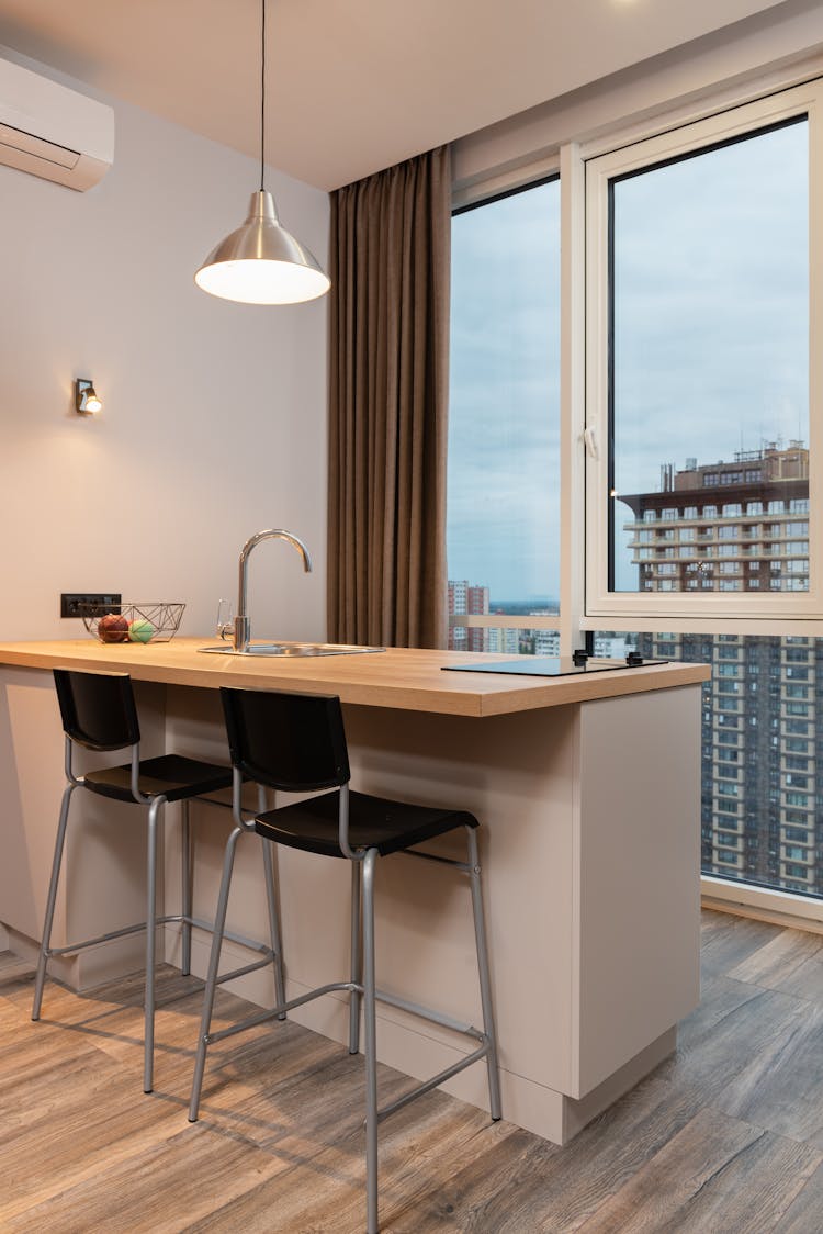 Modern Kitchen With Table And Chairs Near Big Window