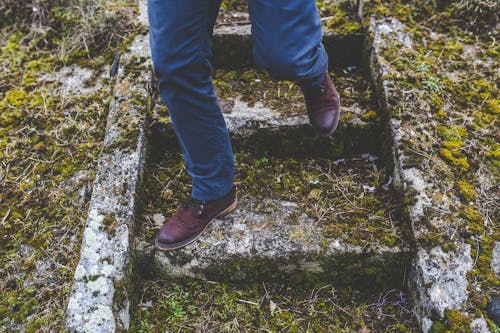 Man walking down the old stone staircase