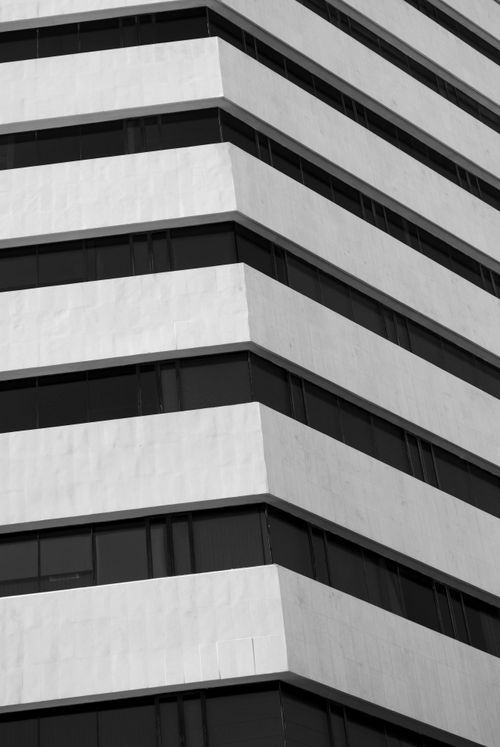 Free Monochrome view of a modern building facade with geometric patterns. Stock Photo