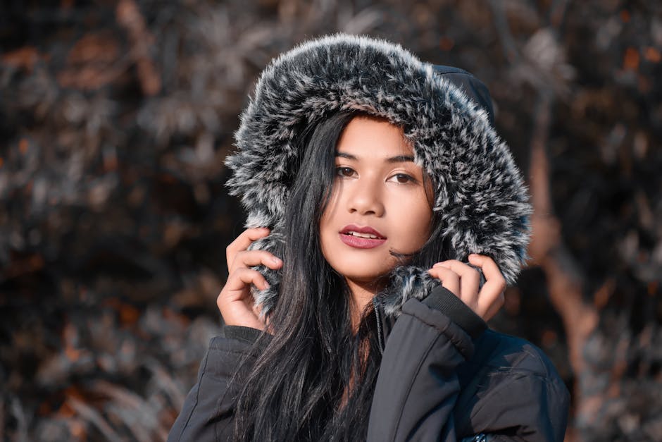 Shallow Focus Photo of Pretty Woman in Black Fur Coat Looking at Camera