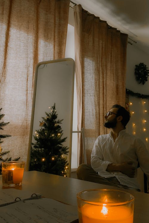 Man and Reflection of Christmas Tree in a Mirror