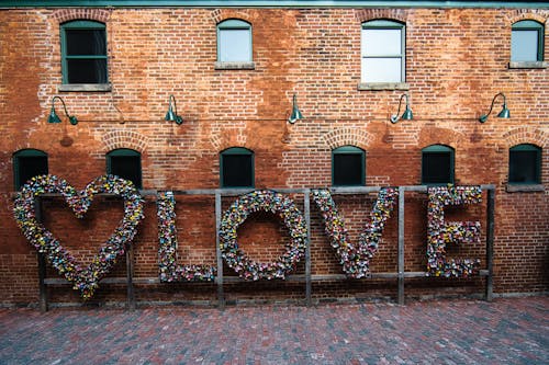 Free Love Word Decoration on Red Brick Concrete Wall Stock Photo
