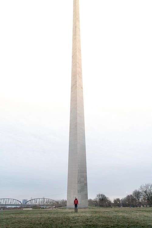 A Person Standing in Front of the Gateway Arch in St. Louis