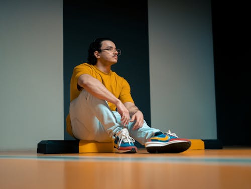 Man Sitting on Gym Floor