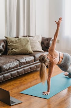 A woman in activewear performs a yoga side plank in a cozy living room setting.