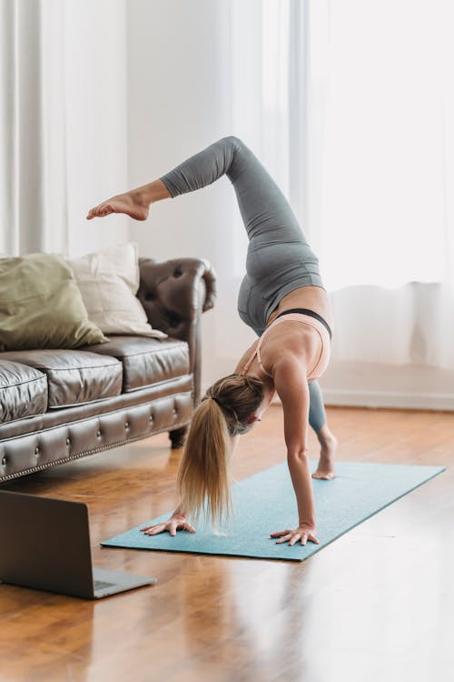 Free Woman Doing the Downward Facing Dog Pose Stock Photo