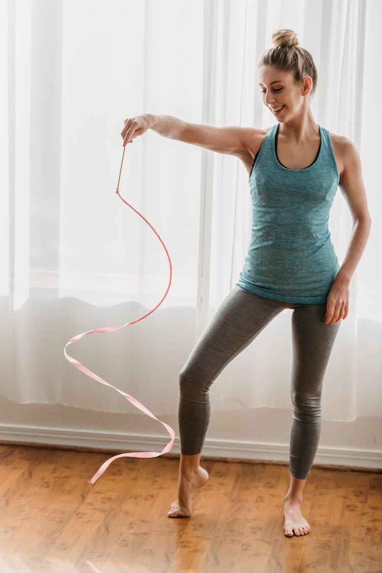 Smiling Sportswoman Doing Exercises With Gymnastic Ribbon