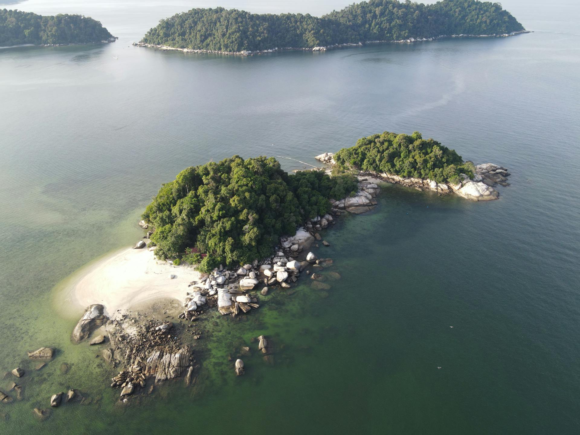 Aerial view showcasing beautiful tropical islands in Malaysia surrounded by serene sea waters, ideal for travel and nature lovers.