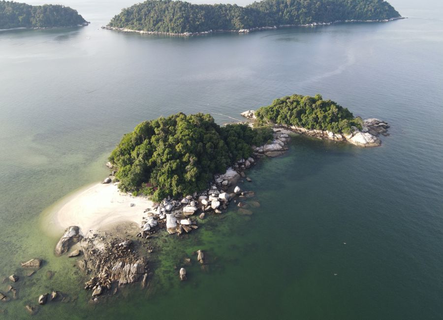 Aerial view showcasing beautiful tropical islands in Malaysia surrounded by serene sea waters, ideal for travel and nature lovers.