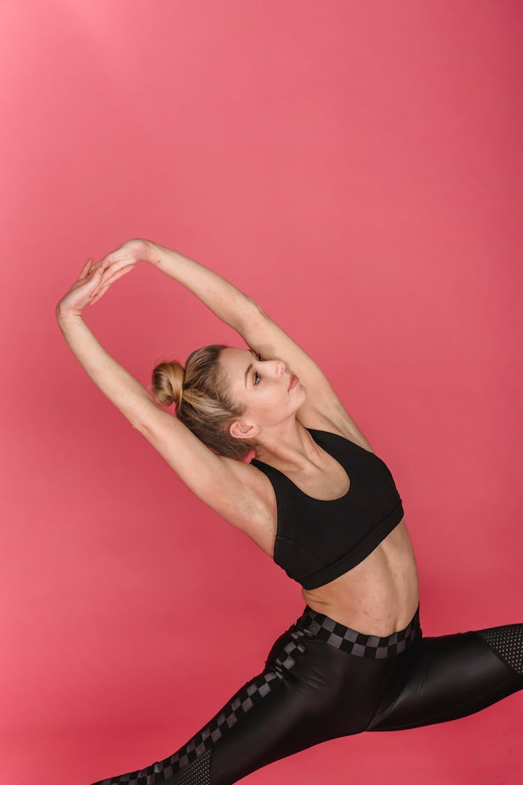 Fit Woman Doing Lunge With Hands Up