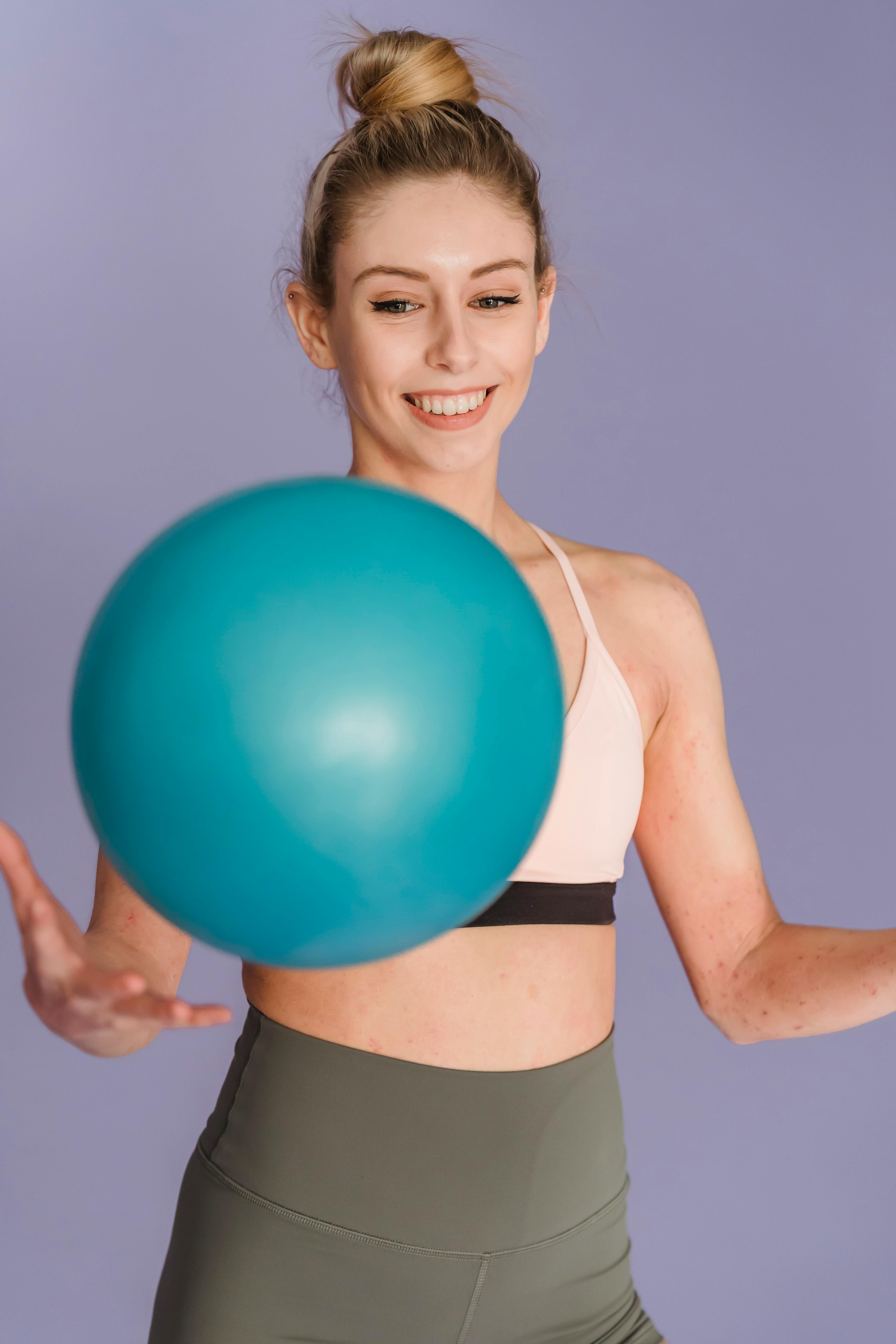 happy sportive woman exercising with ball