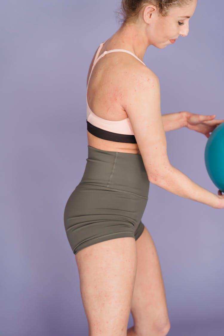 Slim Woman Exercising With Gym Ball