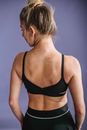 Slim woman with muscular back in activewear