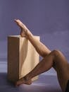 Dancer reaching out leg on wooden cube