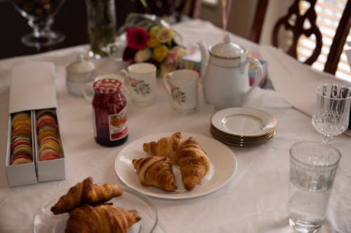 Delicious Croissants and Macarons on a Dining Table