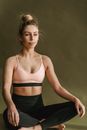 Woman sitting on floor in Padmasana