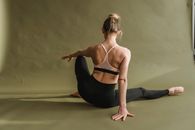 Flexible woman doing yoga in studio