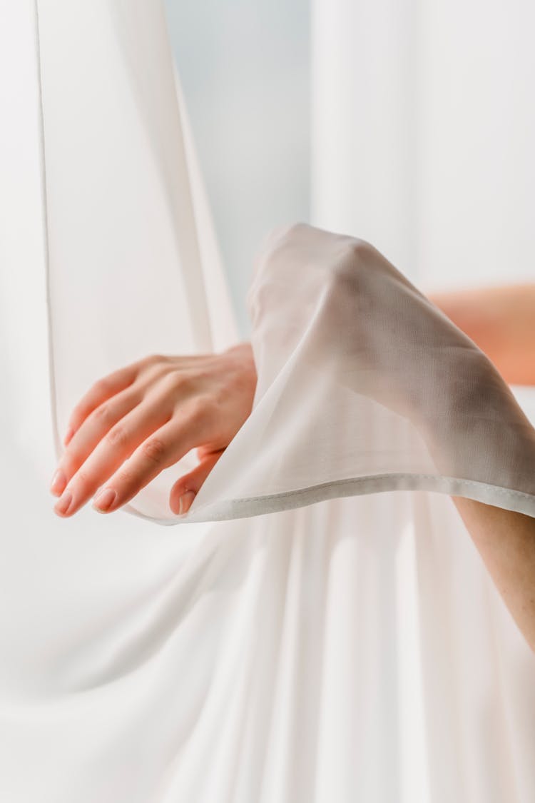 Faceless Woman Touching Chiffon Curtains Tenderly