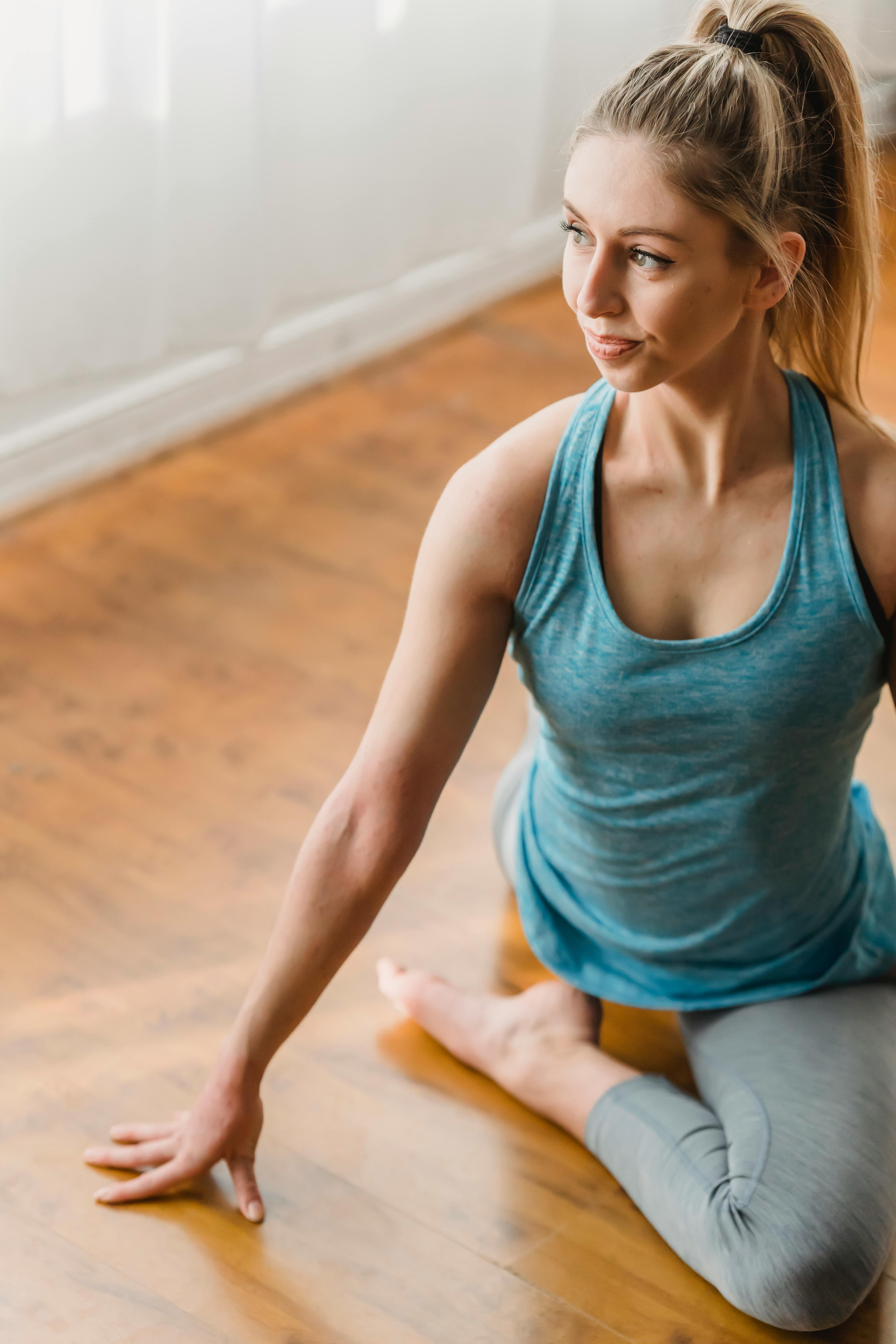Woman practicing yoga while showing Eka Pada Rajakapotasana