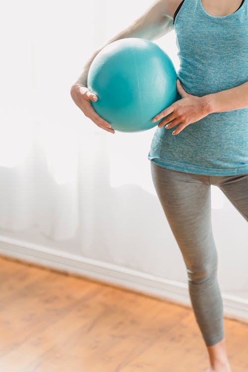Free Woman with fit ball in light gym Stock Photo